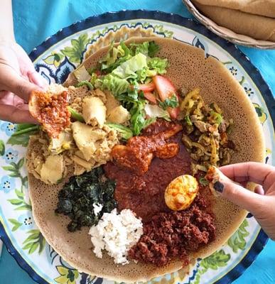 meat combo (lamb, beef & chicken dish) w/ gomen (collard greens) & ayib (ethiopian cottage cheese)