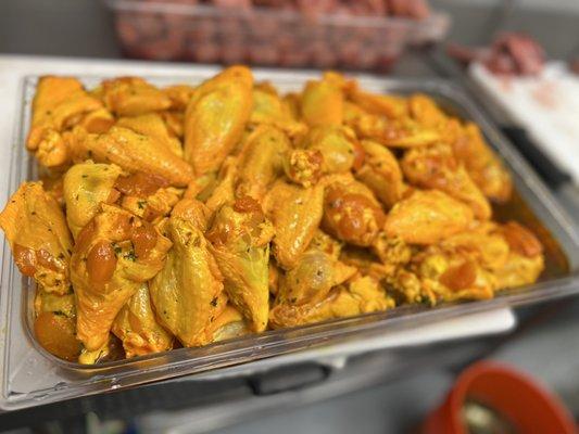 Seasoning wings with yellow sauce