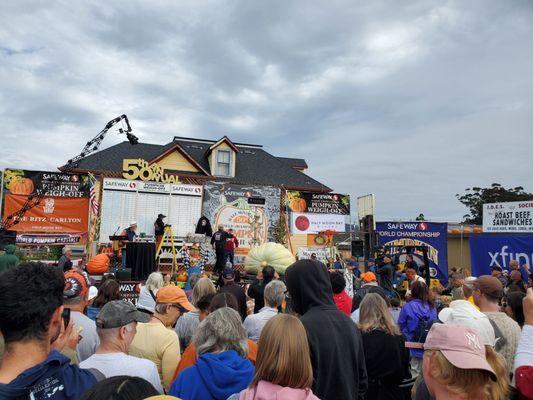 Giant pumpkin being weighed on stage