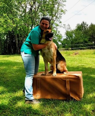 Dr. Lizzie is hugging a German Shepard.