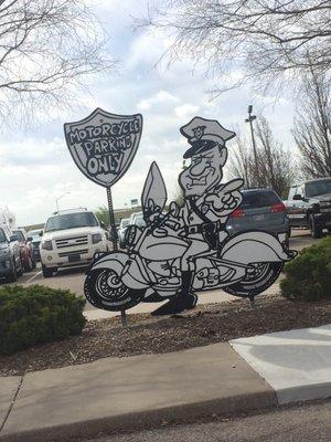 Motorcycle and guest parking near the church's front entrance.