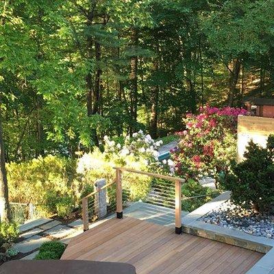 A lakeside deck with built in hot tub and custom fencing