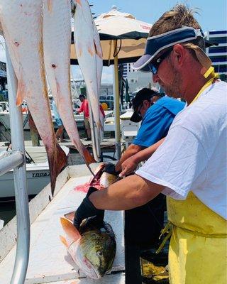 Cleaning and prepping our fish for us to take home!