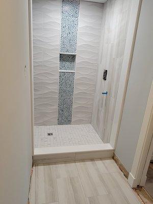 Walk in closet converted to a second bathroom with large shower area