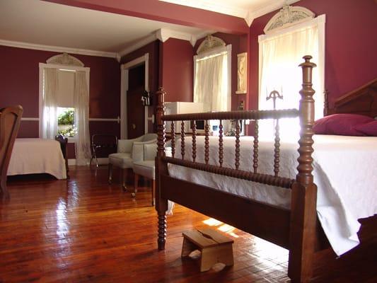 The Olympus guestroom offers two beds.  An antique spindle bed and an antique twin size bed.  There is also one roll-away bed in this room.