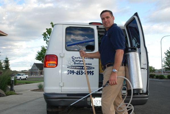 Kyle from Carbonated Carpet Solutions loading up the work van.