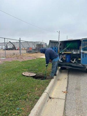 One of our employees cleaning from a manhole