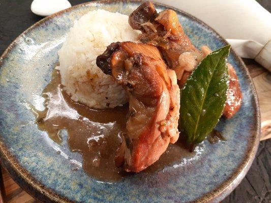 Filipino chicken adobo GF DF Stewed chicken hindquarters with sweet sour glaze, garlic and chile.  Served with rice