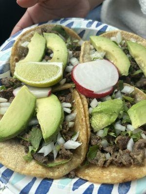 Carne asada tacos with additional avocado slices