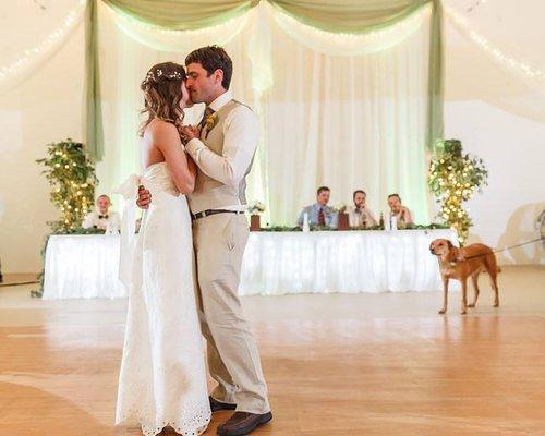 Newlyweds celebrate in The Preserve's indoor event center under a ceiling of lights.