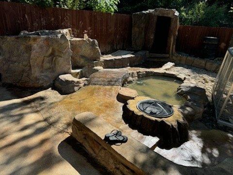 Koi pond firepit in Dallas with a bridge