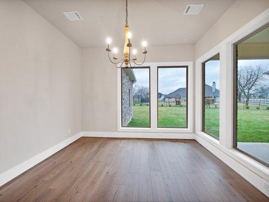 Oversized windows in dining room help bring the outside in