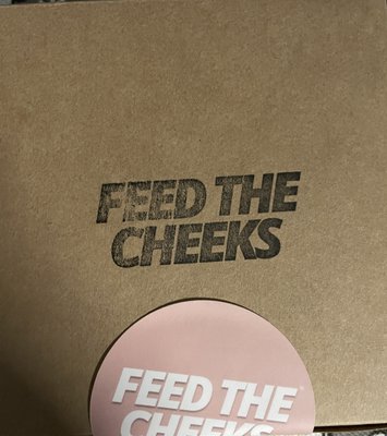 Feed the Cheeks logo on box