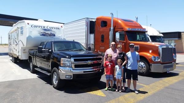 Met up with my father-in-law at a truck stop and snapped a picture of our new trailer from Power RV on its maiden voyage next to his truck.