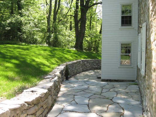 Drylaid limestone retaining wall and 1,000 square foot patio.