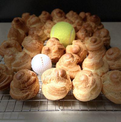 Each Cream Puff size is smaller than a tennis ball but larger than a gold ball!