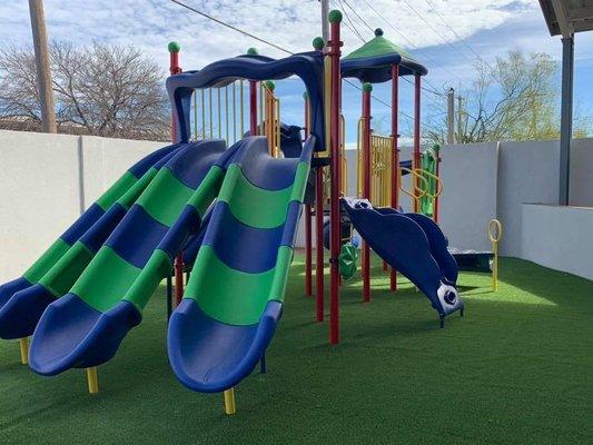 outdoor cabana has a playground.