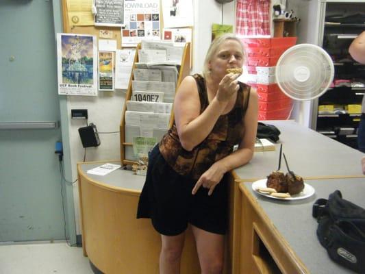 Scruffy tourist shoving large cookie in mouth