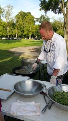 Chef Chris Wadsworth of Triumph Kitchen cooking up deliciousness at Slow Food Baton Roug "Dinner In The Field"