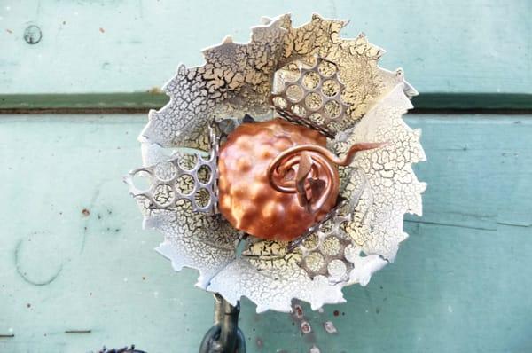 Metal flower sculpture, made from recycled saw blades and copper