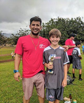 My son, Daniel smiling next to his coach.