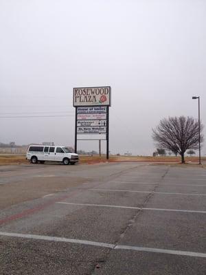 The sign to the plaza that the doctors office is located in.