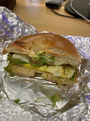 Bacon-less bacon, egg, and cheese with avocado on a plain bagel