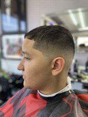 Mid fade haircut with texturized top