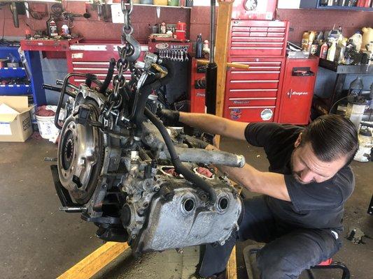 Our lead tech, Ryan Craner pulling a motor out of a Subaru.