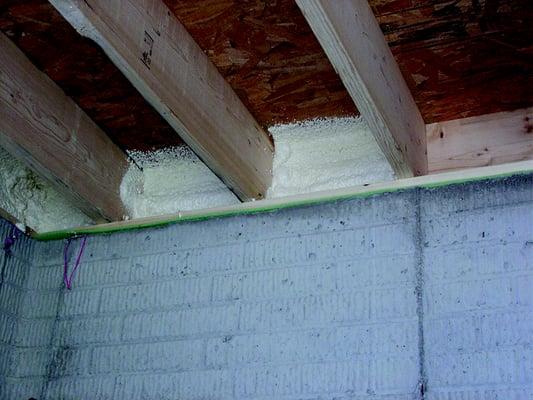 Money saving spray foam insulation in the rim joist (before & after installation).