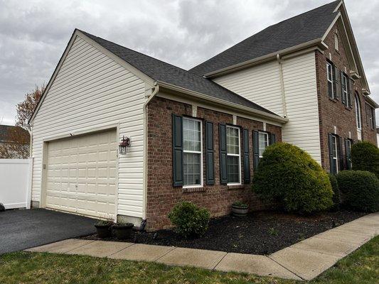 Garage brick face, siding, gutters, soffits and garage door..