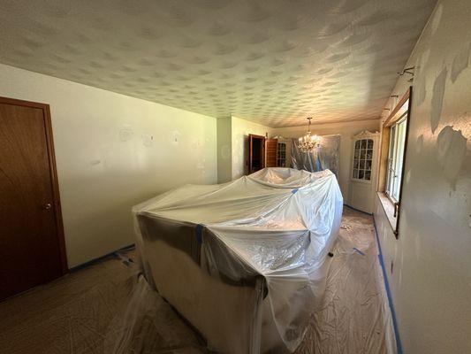 Floors are completely covered, and the holes patched up just before the painting starts.