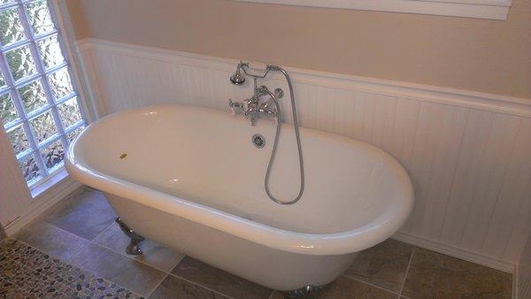 beautiful ball & claw foot tub with wainscoting walls