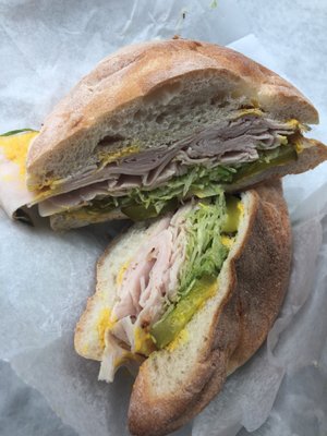 Turkey, lettuce, and mustard on a Portuguese roll