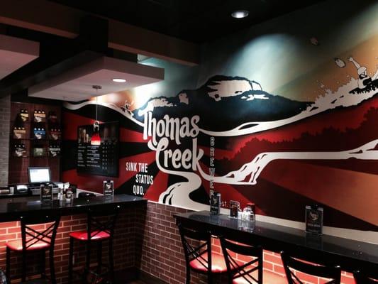 Wall mural featuring Thomas Creek packaging labels and logo by Charleston artist Sean Williams.