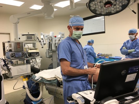 Dr John Sabra performing thyroid ultrasound in the operating room