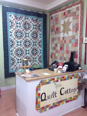 Pretty quilts behind the counter.