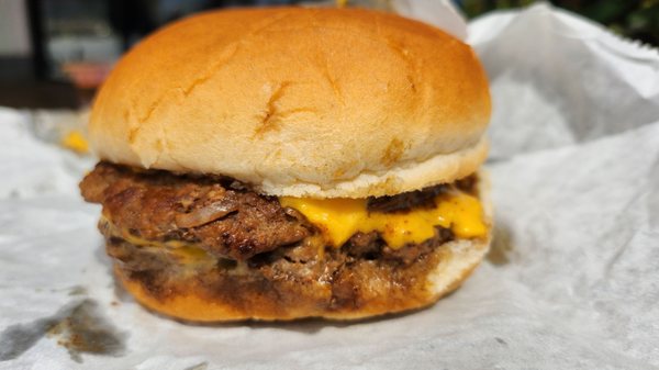 Delicious double cheeseburger with extra cheese request.