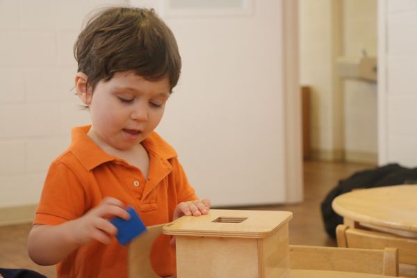 Child working with the Imbucare Box and cube in the Saturday Toddler class.