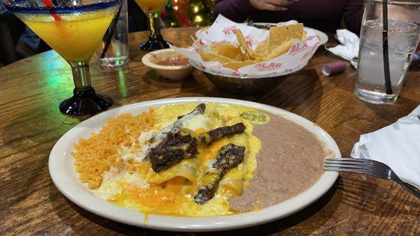 Picantes Enchiladas very deliciosas and super hot and flavorful. Beef fajita on top cooked to perfection!