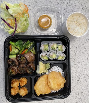 beef rolled around scallions, broccoli & carrots, iceberg lettuce & dressing, rice, sweet potato tempura, shumai, & CA rolls.