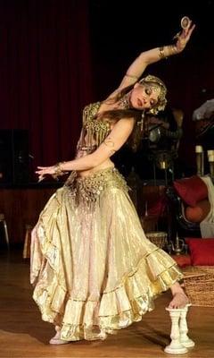 Melina belly dancing on corinthian column candle holders