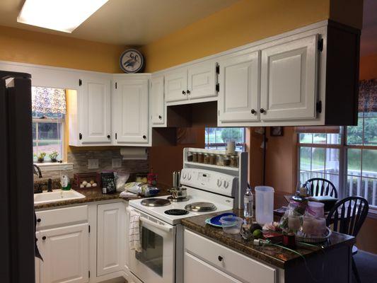 Kitchen Transformation. Painted all walls & cabinets, re-finshed countertops, new stone back splash, new hardware & fixtures, and flooring.