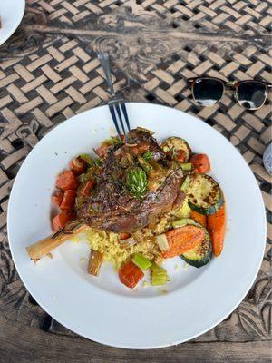 Mediterranean style leg of lamb with rice, zucchini, carrots and rosemary.