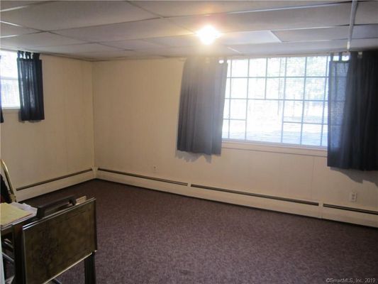 Before photo - Dank carpet and droopy ceiling. Broken window pane.