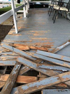 Rotted and coming apart front porch.