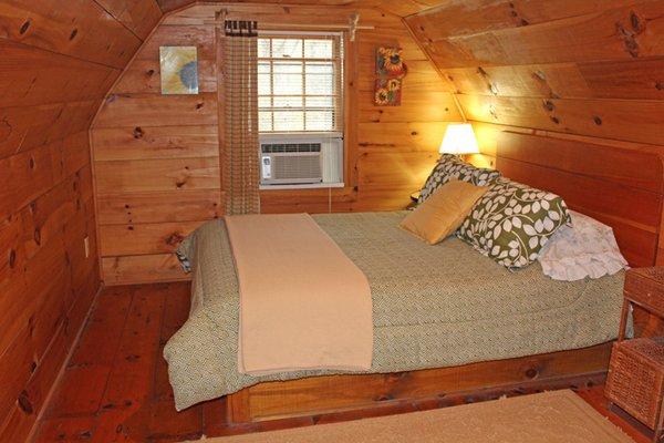 Upstairs in the Cove Cabin is a queen-size bed, a full-size bed in the loft area and a half bath.