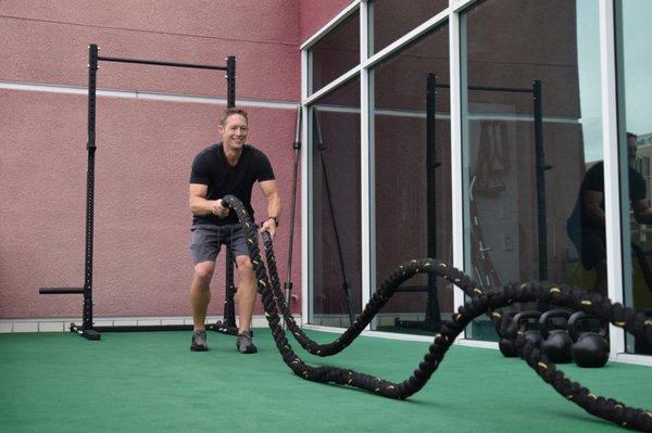 Derek battling ropes on the outside patio.