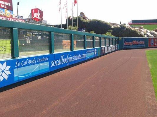 Baseline protective padding in professional baseball venue.