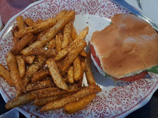 Burger and fries with blackened seasoning.